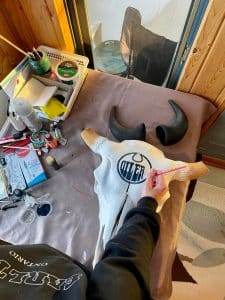 Hand painting a bison skull
