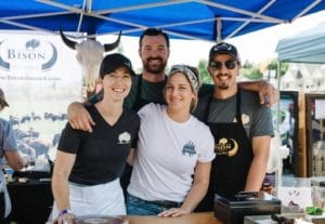 Bison du Nord staff pose for a photo during a beer and food festival